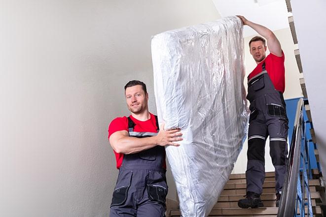 heavy lifting as box spring is transported out of a building in Coronado CA